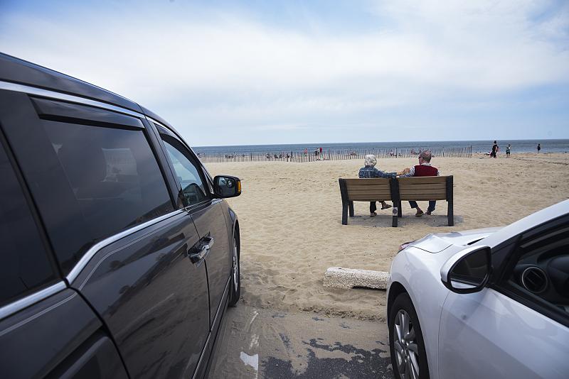 A couple enjoys the day on a bench on Lewes Beach. DENY HOWETH PHOTO